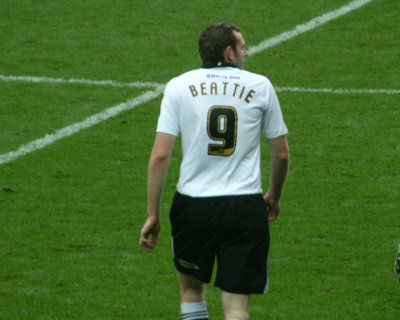 Beattie Hasn't Noticed the Coathanger Left in the Back of His Shirt!