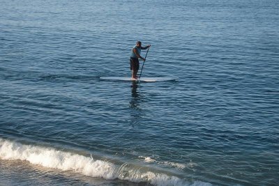 Long paddle surfboarder