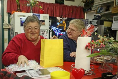 Friends Exchange  Gifts At Cafe For Valentines Day