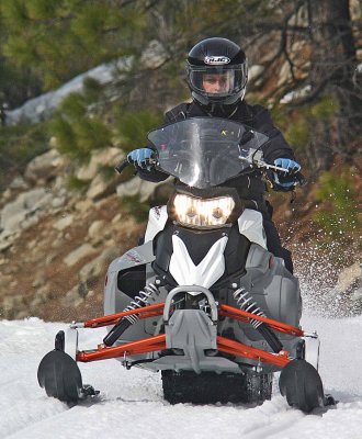 Young Lady Enjoying Late Winter Snowmobiling On Upper Entiat Road