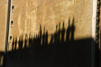 Shadows of people watching the ship transit the lock