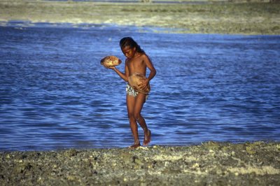 Girl beachcombing at low tide, Tarawa