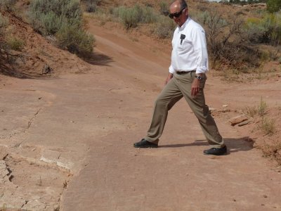 Gary matches his stride with that of the long-gone dinosaur