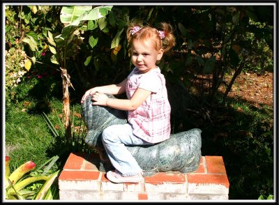 Kylie rides the statue of the caterpillar