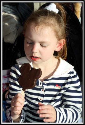 Noelle eats a Mickey ice cream from Grampy