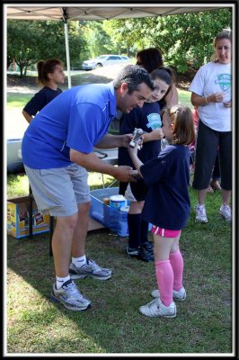 Noelle gets her trophy from Coach Kevin
