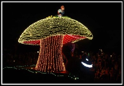 Alice in Wonderland on top of a mushroom
