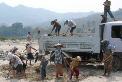 A road crew, including women and children