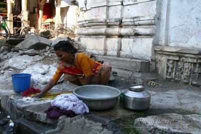 04-Woman washing clothes on sidewalk