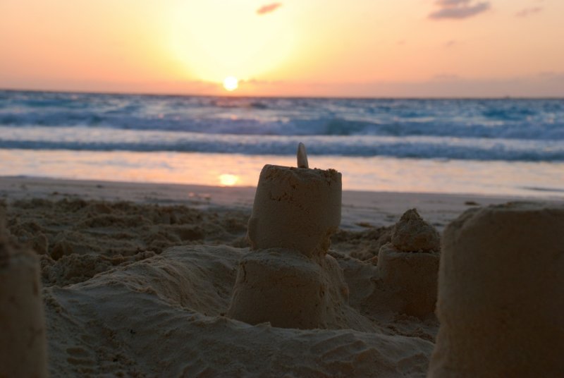 Sand castle on Cancun beach at sunrise
