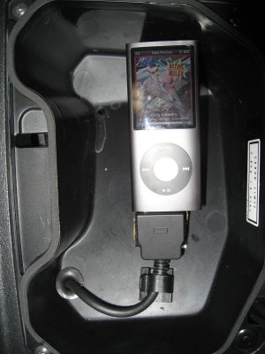 I put a gromment in the hole and the support holds the Ipod up so I can still use the glove box and put stuff under it.