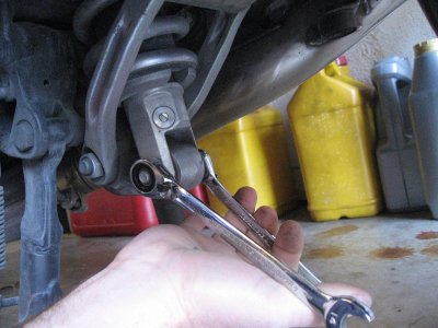 Loosen and remove bottom shock nut