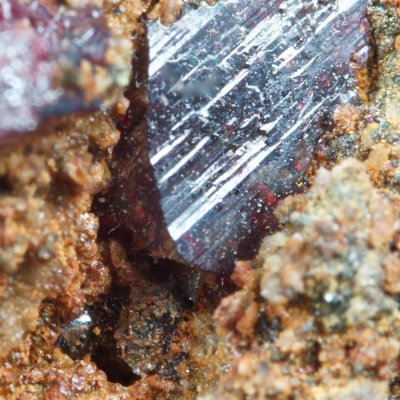 Mercury droplet with cinnabar crystal (5 mm). Las Cuevas mine, Almaden, Ciudad Real Province, Spain.