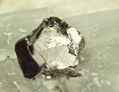 Sharp 4 mm graphite crystal on calcite. Namib Mine, Wlotzkas Baken, Erongo Region, Namibia.