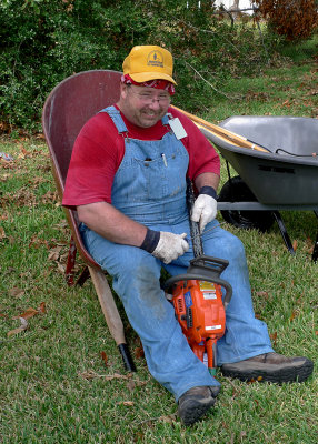 A WHEELBARROW MAKES A NICE SEAT FOR SHARPENING THE CHAIN!