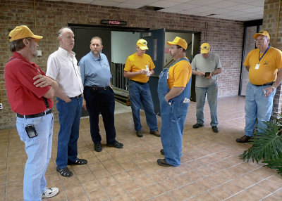 TEAM MEMBERS TALK WITH THE CHURCH PASTOR AND A CHURCH MEMBER