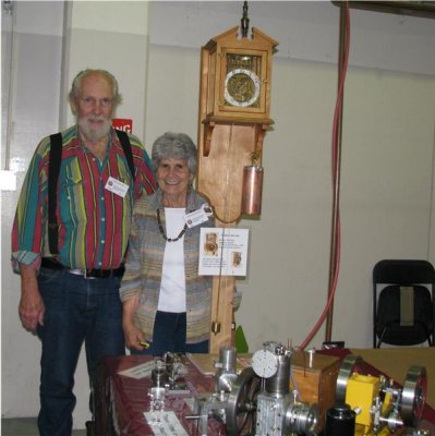 (101)   Carl and Carole Felty in front of their clock.