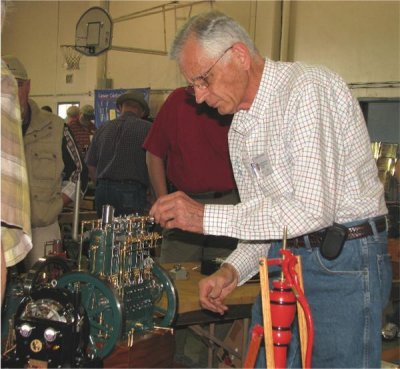 (153)   Larry Smith makes some adjustments to his Fairbanks Morse 3 cylinder