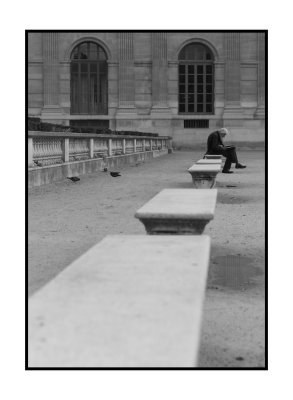 Man reading by the Louvre, Paris
