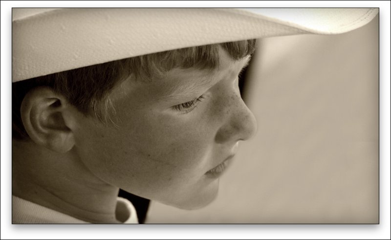 Kid At HThe Fair Watching Rodeo