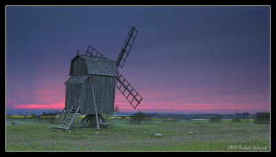 Windmill on land at Sunset