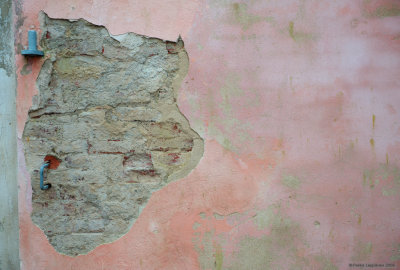 A wall with falling plaster