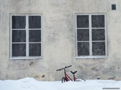 Bike in snow between (no) windows