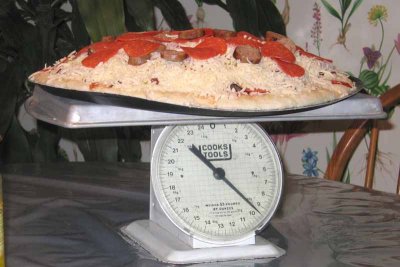 The metal pan weighed 3/4 pound, making 8 3/4 pounds for the pizza