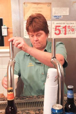 Nice lady pulls beer for visitors