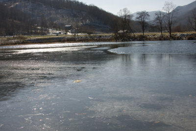 Pond Partially Covered by Ice