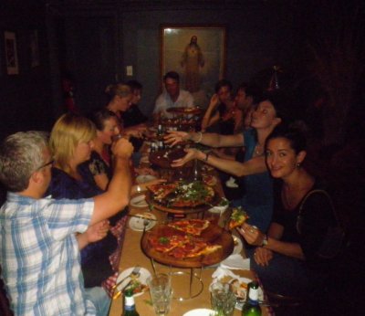 Laura and a group eating pizza in Sydney