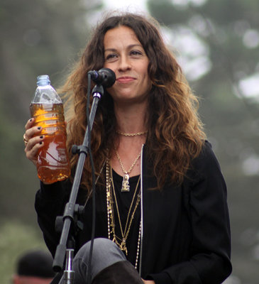 Alanis Morissette performing with acoustic trio