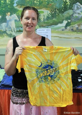 Marketplace crew member Meaghan shows off WorldFest T-shirt