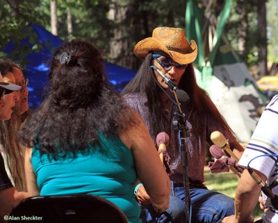 Lawrence Laughing performs with Loping Wolf native flute and drum group, Oak Tree Stage