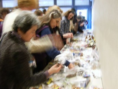 The blurred hands plucking at the choice seed packets!