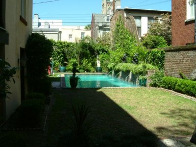 In the next garden; a great pool overgrown with vines