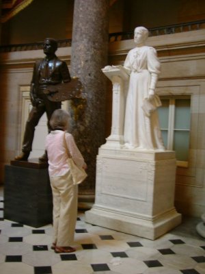 Joan looking at a statue