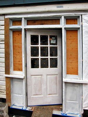 New door to the waiting room is installed in the restored old frame.