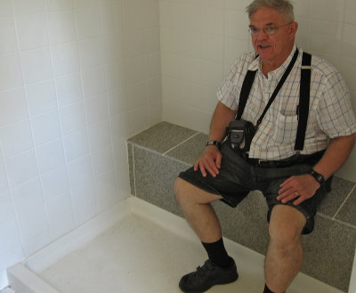 Ted sits in the Bathroom Shower