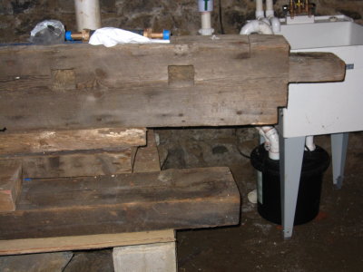 In the basement, an old beam in front of the sink