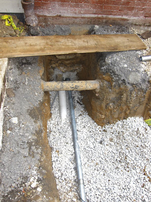 Where the conduit and pipe emerge from the cellar