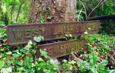A rusty iron sign beside the platform