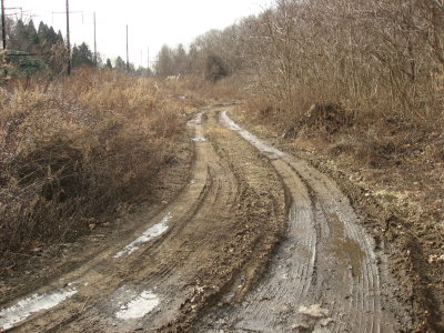 Behind the fill, a road leads from the trail up to Westminster Cemetery