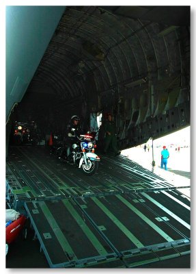 Motorcycle police coming down the ramp of the C-5 Galaxy
