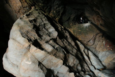 Large rock inside sea cave. Leo Barker in distance.