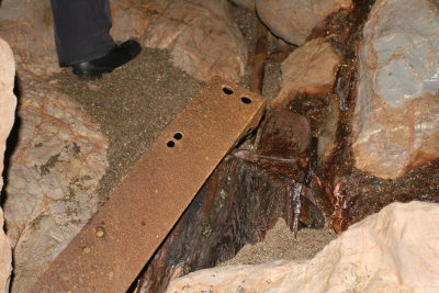 Unidentified metal and wood on floor of cave