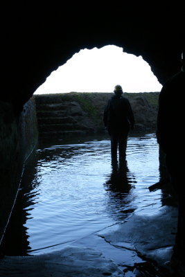 Tom Bratton framed in opening from channel into catch basin