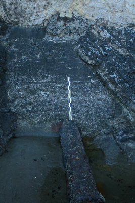 Outflow pipe & concrete filled cleft in rock face.