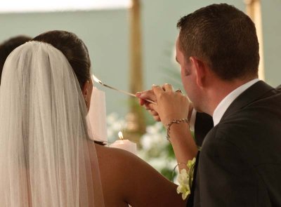 The couple light their candle after taking their vows