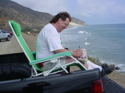 Jeff writing postcards<br>from Malibu California